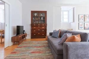 uma sala de estar com um sofá e uma televisão em Downtown Charming Apartments Apartamento Poldras em Chaves