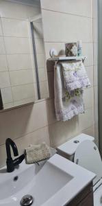 a small bathroom with a sink and a toilet at Village home in Chios
