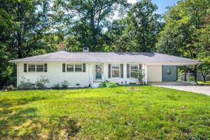 a white house with a grassy yard at Pet Friendly Cozy 3BRM fully Fenced yard in Durham