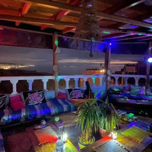 a room with a couch and a table with lights at Rayane Guest House in Taghazout