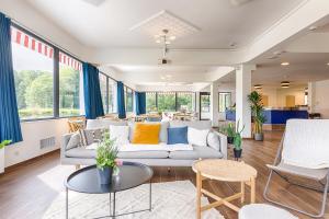 a living room with a couch and a table at La Coudraie - Proche de Disneyland in Montévrain