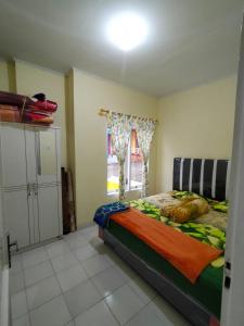 a bedroom with a bed and a window at Villa Highland No 7 M Berastagi View in Berastagi +20 photos