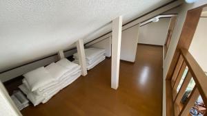 Postel nebo postele na pokoji v ubytování ゼロベース下関室津
