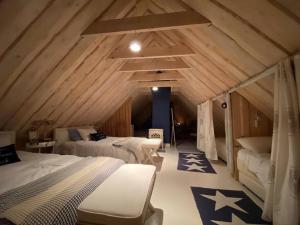 a bedroom with two beds in a attic at Kadakamarja (Juniper) Residence 