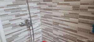a shower with a glass door in a bathroom at Lefterakis place in Egina +20 photos