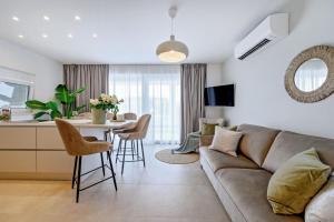 a living room with a couch and a table at Luxury Villa Del Sogno with pool, jacuzzi, parking in Trogir