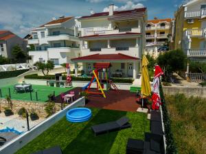 a backyard with a playground with a play equipment at Vila Maričić in Sveti Petar