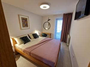 a bedroom with a bed and a television in it at Apartments Cerin-Rovinj in Rovinj