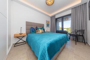 a bedroom with a bed and a table and a chair at Apartman SeaSide 8 in Banjole +35 photos
