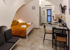 a bedroom with a bed and a dining room at Stefano's house in Catania