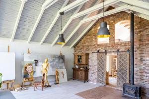 a room with a brick wall and two pendant lights at Aquarela Studio in Łęcze