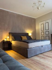 a bedroom with a large bed and a couch at Plaza Apartment in Cannobio