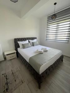 a bedroom with a large bed in a room at Apartment All Seasons in Ulcinj
