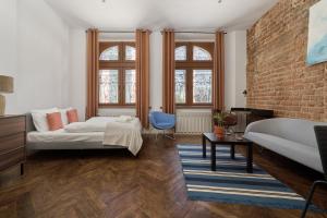 a bedroom with a bed and a brick wall at 350m to the Market Square - Św Antoniego Apartment by Renters in Wrocław
