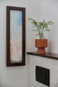 a plant in a pot sitting on top of a fireplace at 350m to the Market Square - Św Antoniego Apartment by Renters in Wrocław
