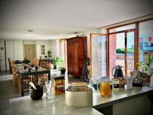 a kitchen with a counter top and a kitchen with a table at Domaine Joseph LAFARGE Wine Resort B&B in Lugny
