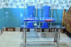 two blue chairs on a table with glasses on it at HOLIDAY INN in Konārka