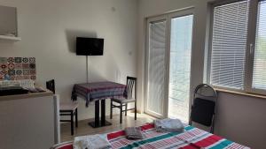 a bedroom with a bed and a table and windows at Villa Stedar in Ohrid +95 photos