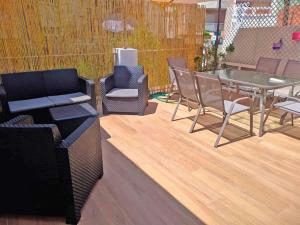 a patio with chairs and a table and a table and chairs at Piso recién reformado con gran terraza in Xeraco