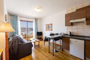a kitchen and a living room with a table at Apartmento Cactus II in Los Cristianos