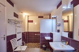 a bathroom with a sink and a shower at Gite Les Galets Chantants Saint hilaire du rosier in Saint-Hilaire-du-Rosier