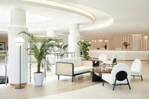 a lobby of a hotel with chairs and tables at Iberostar Selection Creta Marine in Panormos Rethymno