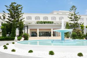 a hotel with a fountain in front of a building at Iberostar Selection Creta Marine in Panormos Rethymno