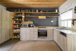 a kitchen with wooden cabinets and a counter top at Rose Willow, Vourvourou #FeelsLikeHome in Vourvourou