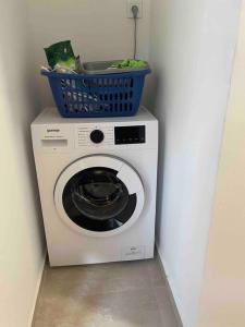 a washing machine with a basket on top of it at Comfortable apartment of 50 square meters in Herceg-Novi