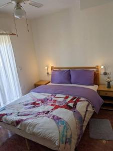 a bedroom with a large bed with purple pillows at House in Orihuela. Sea view. in Orihuela
