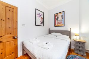 a bedroom with a large white bed with two sinks on it at Stylish 1 BDR apt wcommunal garden, Greenwich in London