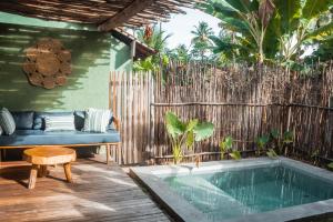 a backyard with a pool and a bench and a fence at Quadrado Pousada in São Miguel dos Milagres