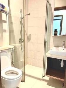 a bathroom with a shower and a toilet and a sink at Centralize Stylish Loft Apartment Near MRT 市中心全景屋 in Singapore
