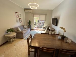 a living room with a table and a couch at Flora Apartments in Puerto Iguazú