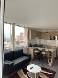 伊基克Edificio Lynch Iquique的客厅里有一张沙发和一个厨房