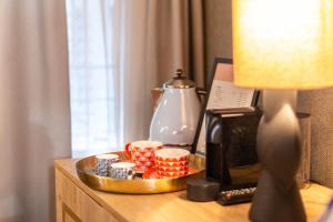 a table with a tray with cups and a lamp at The Melegran in Rovinj