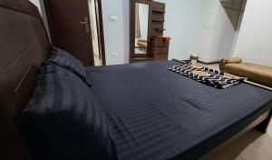 a bed in a room with a blue mattress at Islamabad Airport Guest House Free Pick-up and Drop off Available 24 Hours in Islamabad