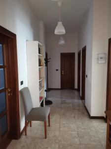 a hallway with a chair and a cross on the wall at Appartamento Scarperia San Piero a Sieve in San Piero a Sieve