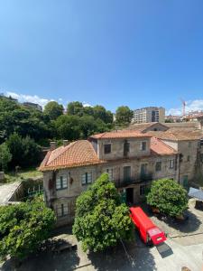 a red van parked in front of a building at PENSIÓN SANTA CLARA in Pontevedra +65 photos
