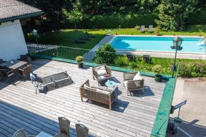 an overhead view of a deck with chairs and a pool at Tirolerhof in Sankt Georgen im Attergau