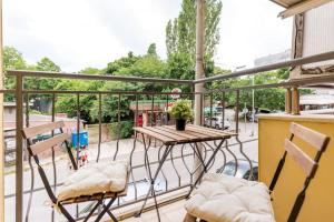 a patio with a table and chairs on a balcony at Stylish apartment on Bregalnitsa str in Varna City
