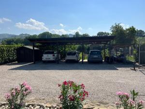 un estacionamiento con dos autos estacionados en él en Assisi, la Noce, en Asís