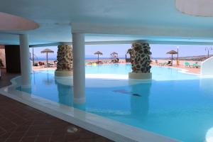 a swimming pool in a hotel with a view of the beach at Lovely Sea View FREE WIFI in Adeje