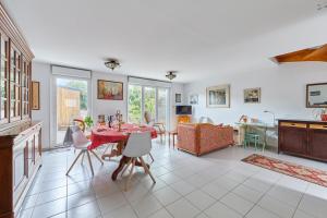 a kitchen and dining room with a table and chairs at Les Rochambelles - Maison avec terrasse in Ifs