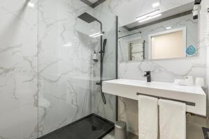 a bathroom with a sink and a shower at Hotel Do Parque - Congress & SPA in Termas de Sao Pedro do Sul