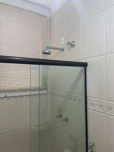 a bathroom with a shower with a glass door at Pousada Pedra Pimenta in Tiradentes