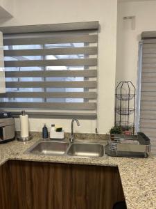 a kitchen counter with a sink and a window at Cancun 16, South 6 Person 3 Rooms 15 min Airport 20 to Beach in Cancún