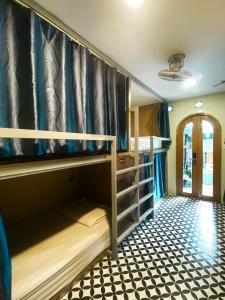 a bunk room with bunk beds and a hallway at VY DA CENTRAL MARKET HOSTEL in Ho Chi Minh City