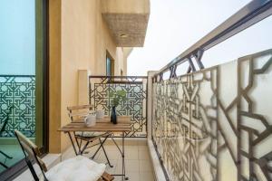 a balcony with a table and chairs on a balcony at GuestReady - Oasis paradise at Riah Tower in Dubai