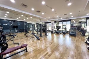 a gym with treadmills and machines in a room at GuestReady - Oasis paradise at Riah Tower in Dubai